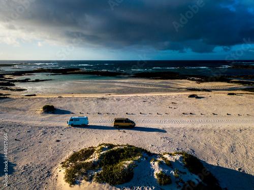 Aerial view of camping vans on sand track in Fuerteventura