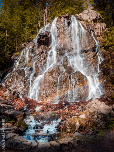 Vertical shot of Radau waterfall on a sunny day - perfect for background photo