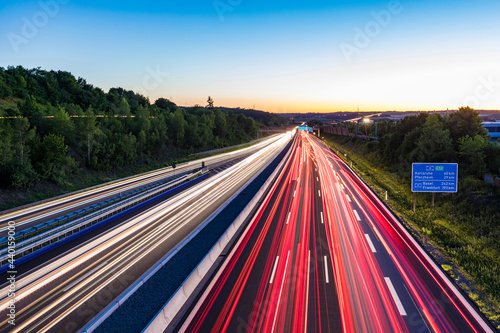 Light trails at a motorway at dusk, Leonberg, Germany photo