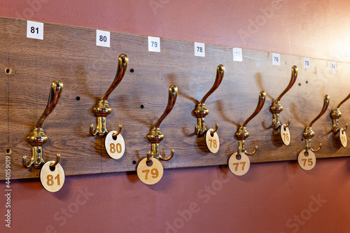 Number labels hanging on hooks in stage theater cloakroom photo