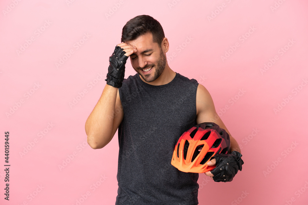 Young cyclist man isolated on pink background laughing - obrazy, fototapety, plakaty 
