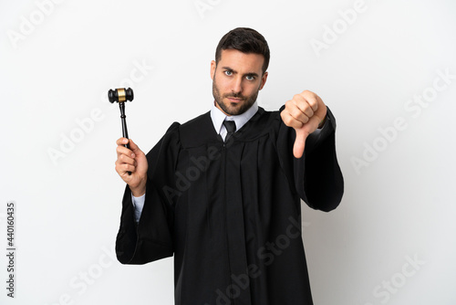 Judge caucasian man isolated on white background showing thumb down with negative expression