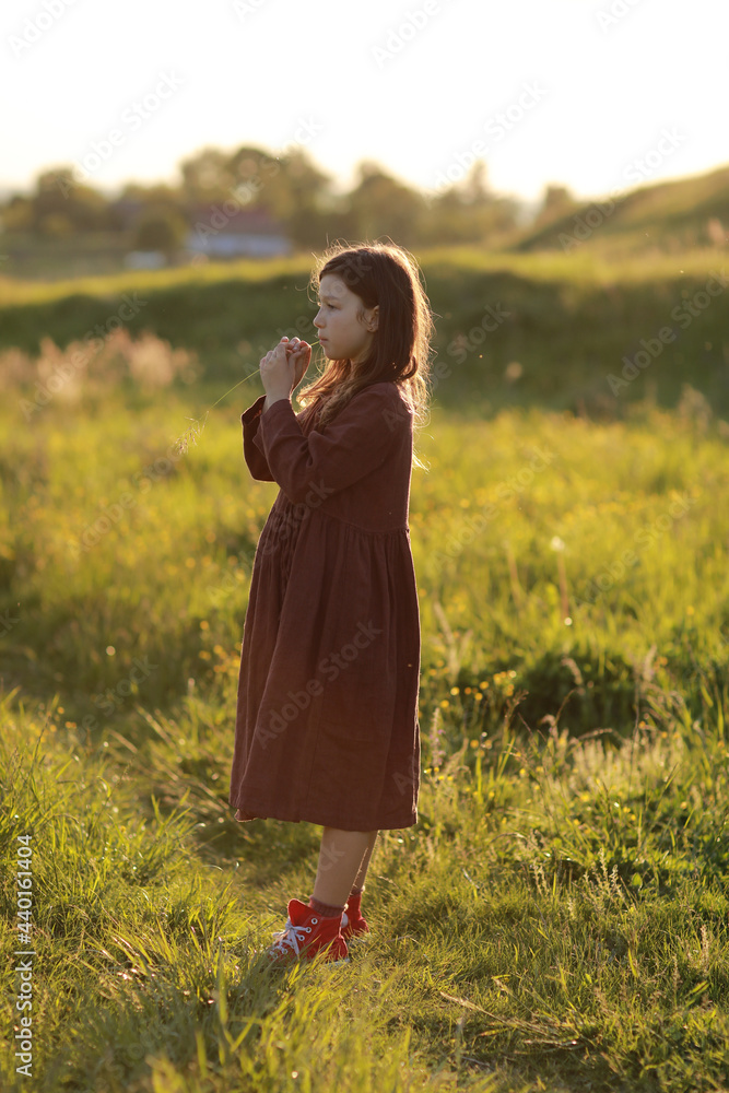 lovely cute little girl playing outdoors at sunset, walking and having fun, happy childhood. summer sunny holiday lovely cute little girl playing outdoors at sunset, walking and having fun, happy childhood. summer sunny holiday