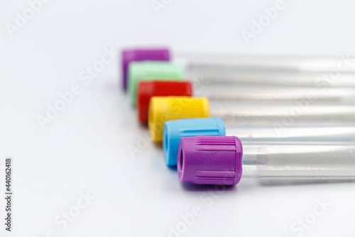 Laboratory concept, Selective focus of test tubes lay on white background, Multi colours of vacuum tube, Lab equipment, Health care check up. photo