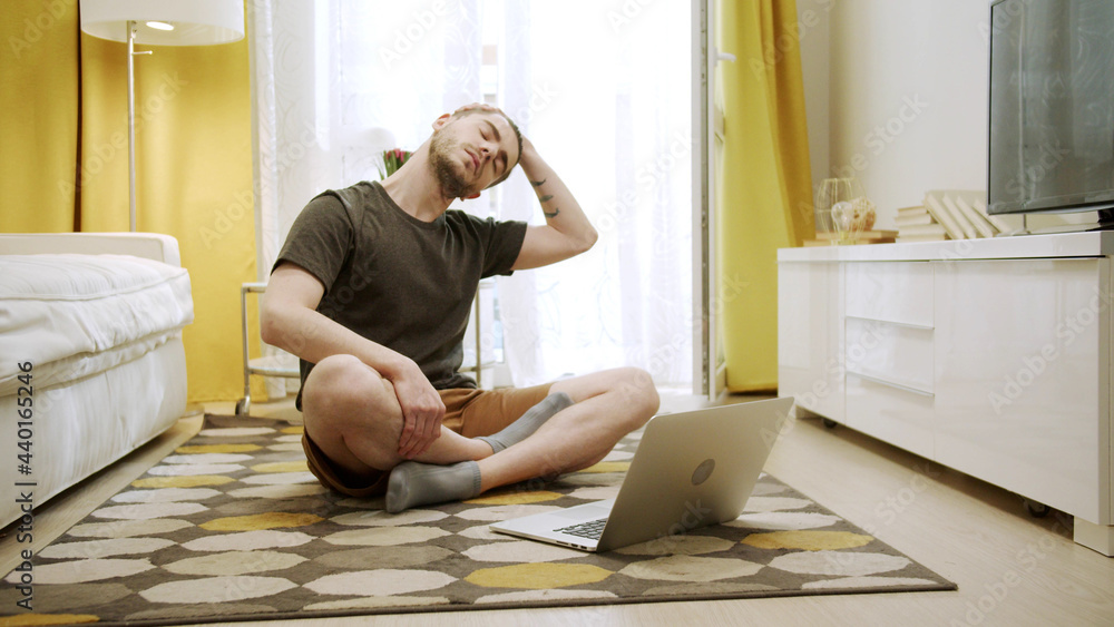 An attractive young man is making healthy exercises on the Internet An attractive young man is making healthy exercises on the Internet