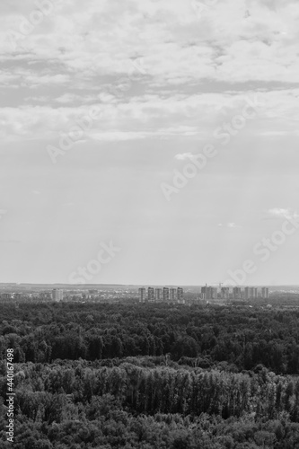 view from a high floor to a new residential district surrounded by a forested area. summer image. Concept of cityscape photography. selective focus 