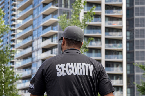 Obraz na płótnie Security guard in uniform patrolling a residential area.