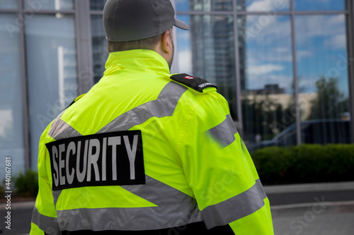 Canvastavla Security guard in uniform patrolling a residential area.