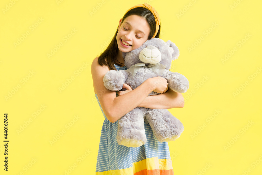 Little girl having fun while embracing a teddy bear Little girl having fun while embracing a teddy bear