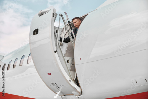 Flight attendant closed door of private airplane