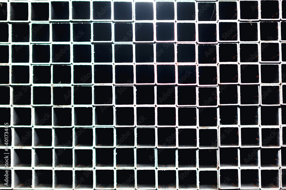 Squares holes background . Stainless steel profiles . Squares shaped pattern