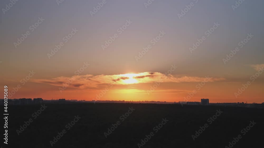 Sunset over the forest, the sun sets behind the city and the trees in the park Sunset over the forest, the sun sets behind the city and the trees in the park