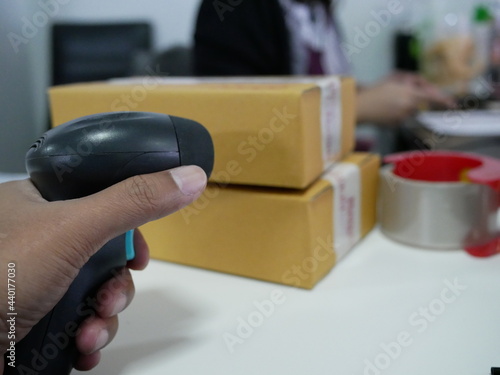 hand holding barcode scanner in the office. © Chanonnat
