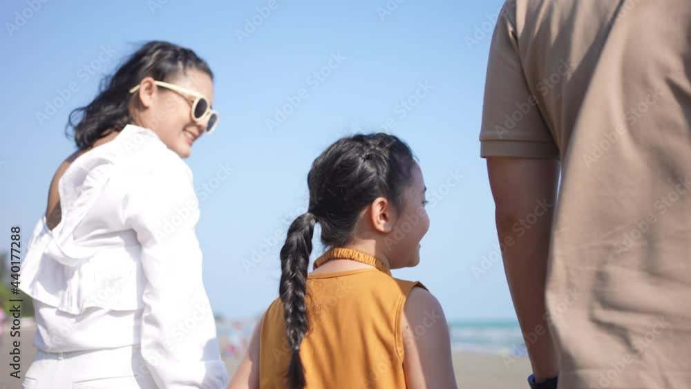 Happy family on summer holiday vacation. Asian couple with little child girl kid holding hands and walking together on tropical beach. Family enjoy and having fun outdoor activity lifestyle in summer. Happy family on summer holiday vacation. Asian couple with little child girl kid holding hands and walking together on tropical beach. Family enjoy and having fun outdoor activity lifestyle in summer.