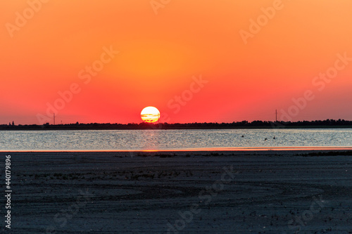 Beautiful orange sunset over a salt lake