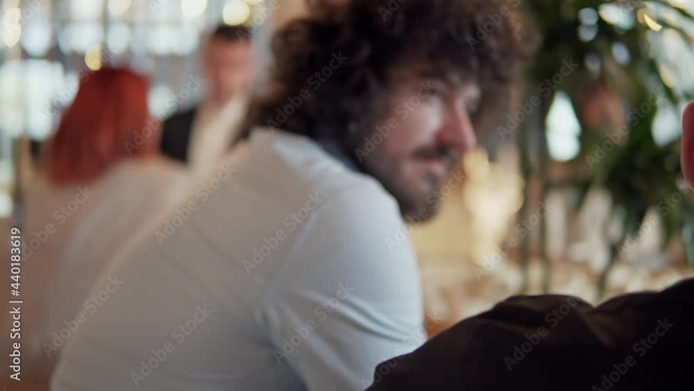 Focused male and female coworkers in formal wear chatting, discussing business in a cafe shop. Business people concept Focused male and female coworkers in formal wear chatting, discussing business in a cafe shop. Business people concept