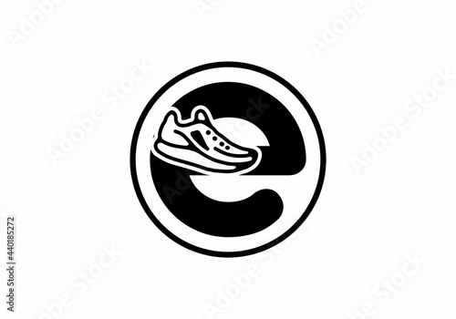 Black E initial letter with shoes in circle