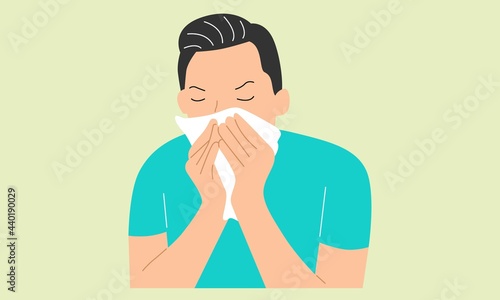 Sick young man holding tissue, sneezing into handkerchief, blowing running nose