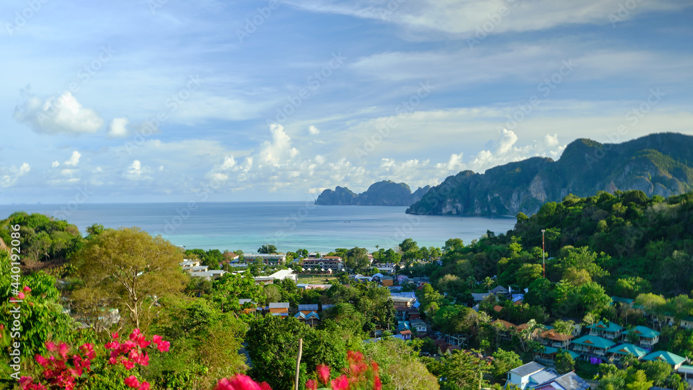 panoramic view from high angle viewpoint on Phi Phi Island, beautiful tourism places like paradise Overlooking house Buildings from hotels and resorts to the seacoast and blue sky.