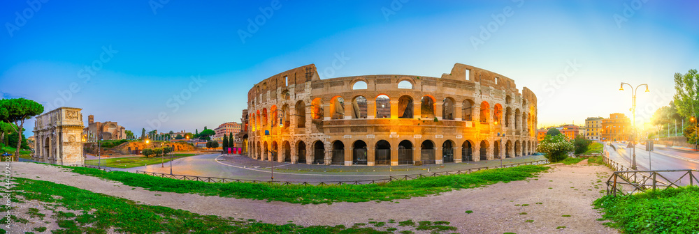 Colosseum and Constantine arch at sunrise in Rome, Italy 