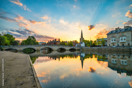 Bedford bridge at sunset with tower of St. Paul's church in the background 