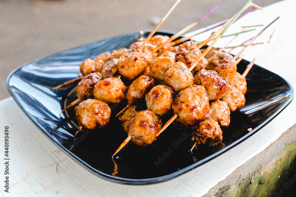 Cooking Barbecue Meatball Satay in grilling stove. This is Indonesian Traditional Street Food made from meatball.