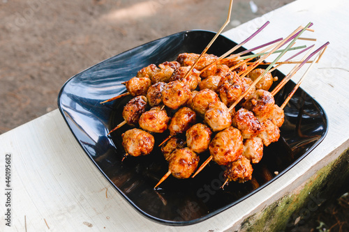 Cooking Barbecue Meatball Satay in grilling stove. This is Indonesian Traditional Street Food made from meatball.