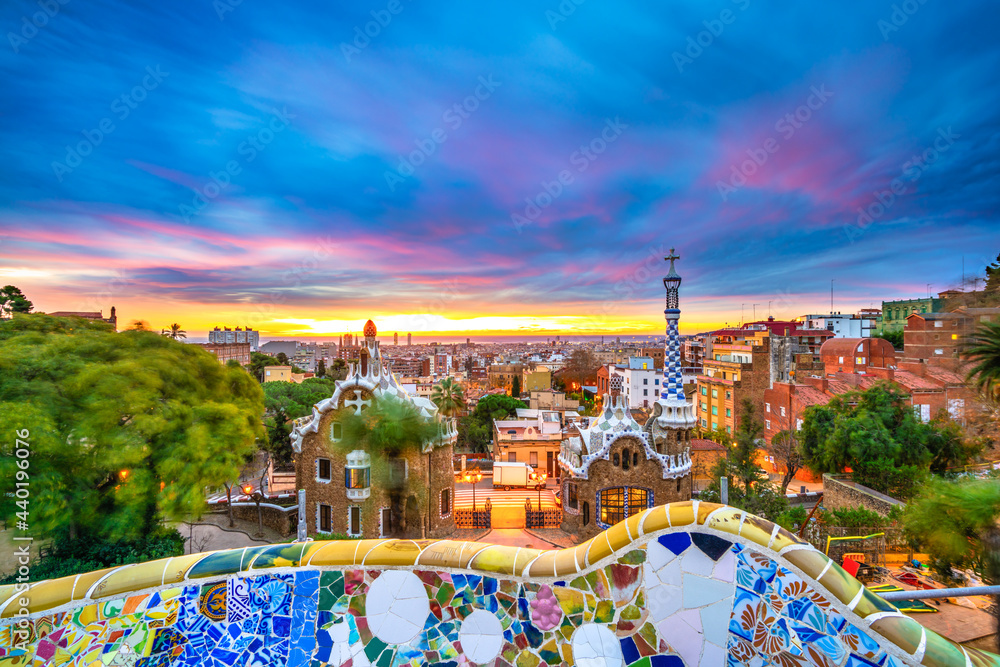 Obraz premium Beautiful sunrise in Barcelona seen from Park Guell. Park was built from 1900 to 1914 and was officially opened as a public park in 1926. In 1984, UNESCO declared the park a World Heritage Site