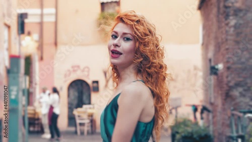 joy, happiness - woman walking in Trastevere makes a pirouette and smiles
