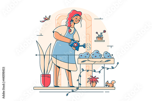 Woman gardener watering gardens flowers