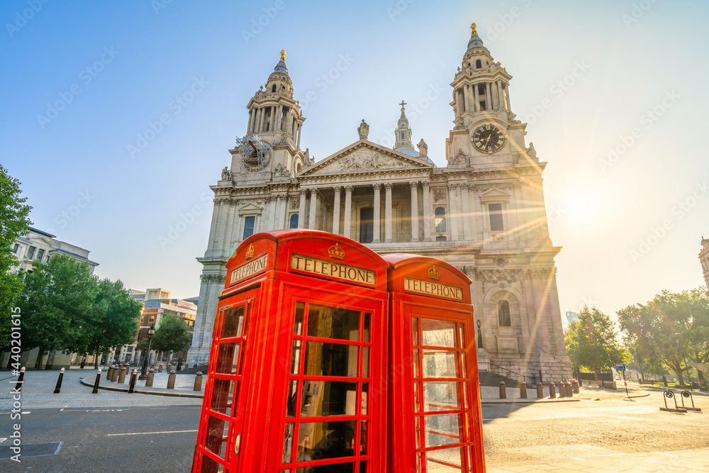 Red Telephone booth with sun flare near St Pauls Cathedral in London