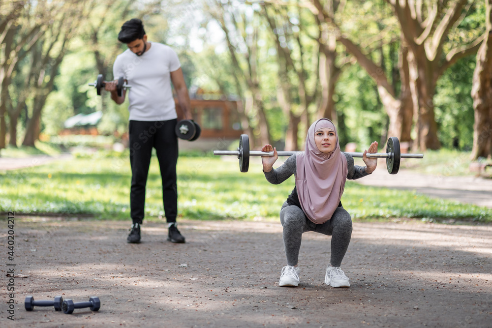 Sporty fit woman, athlete, egyptian and muslim with dumbbells