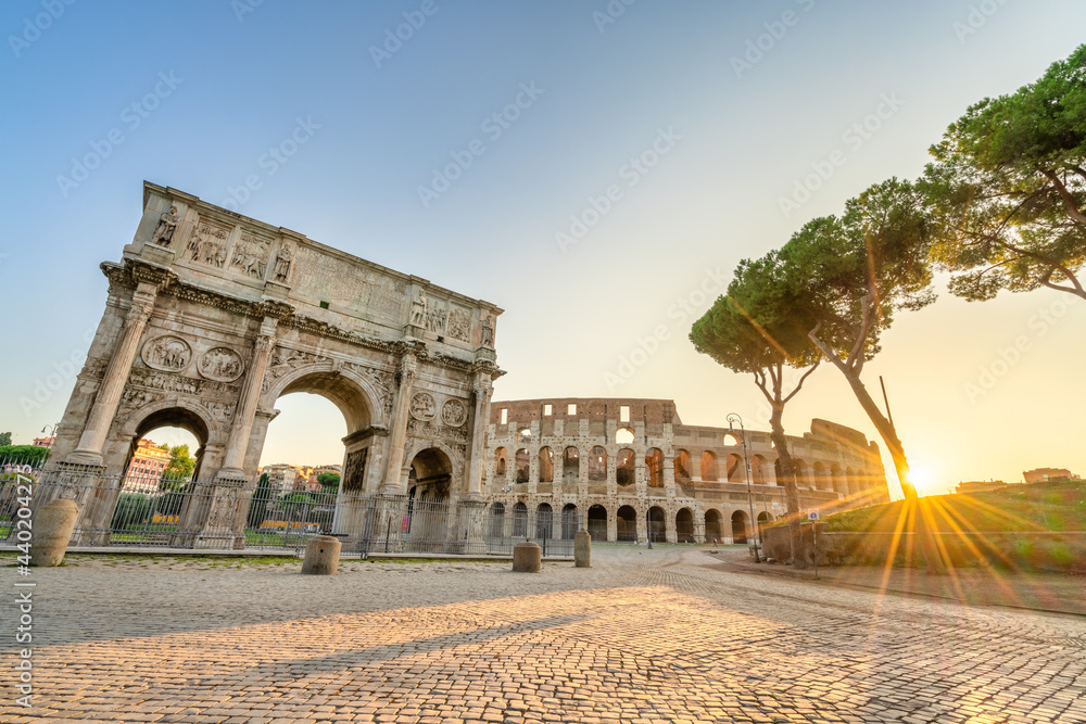 Arch of Constantine and Colosseum at sunrise in Rome. Italy