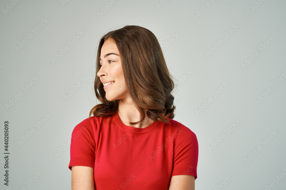 Obraz premium pretty brunette in red t-shirt posing fashion studio
