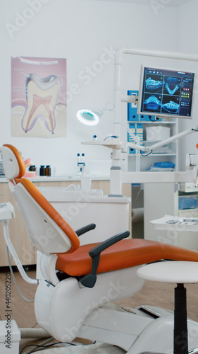 Interior of dentist stomatology orthodontic office with teeth radiography on monitor. Empty dental hospital room with nobody in it prepared for tooth diagnosis. Zoom in shot of medical workplace