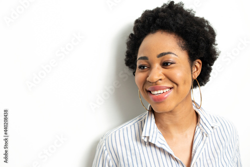 Portrait of a smiling African young woman in a shirt.