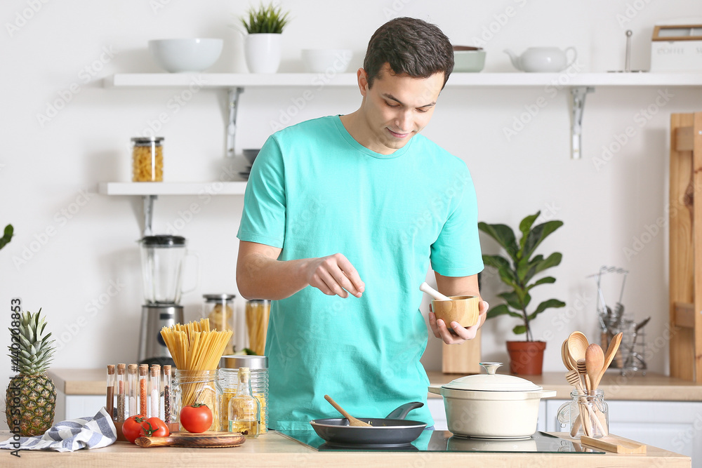 Young man cooking in kitchen Young man cooking in kitchen