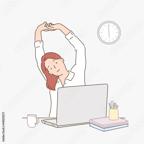 A woman is stretching in the office.