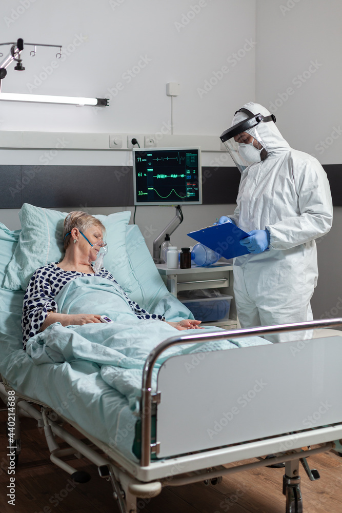 Senior woman patient laying unconscious in hospital bed during