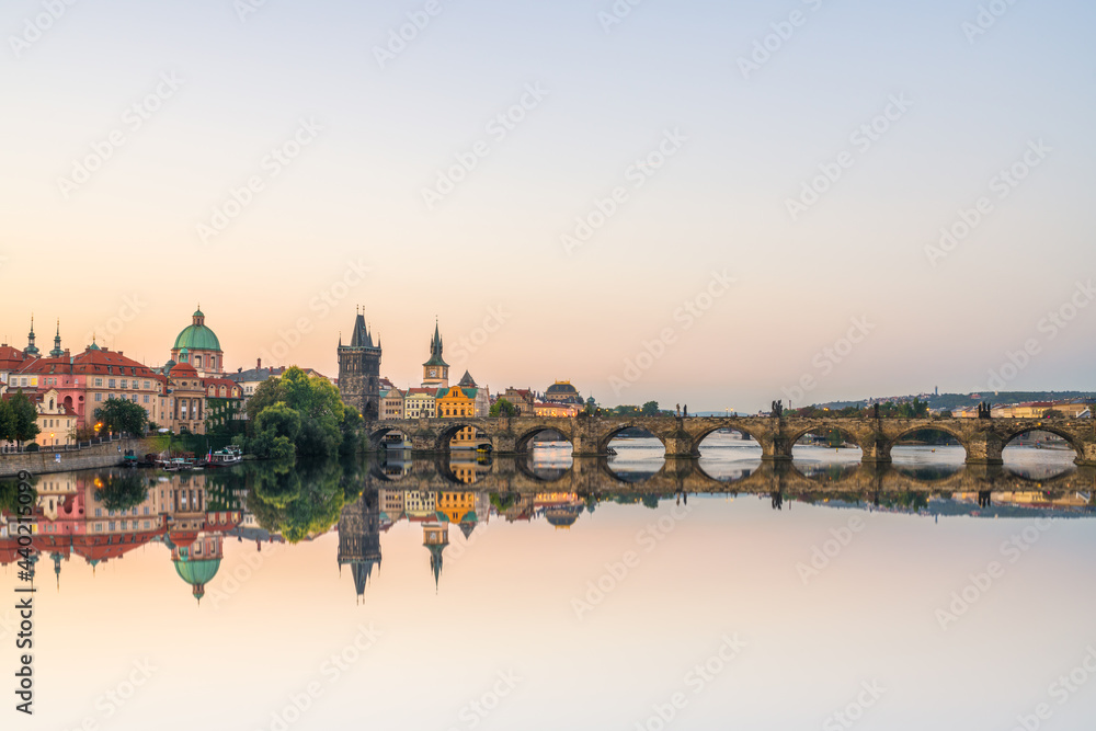 Charles bridge at sunrise with reflection. Prague, Czech Republic