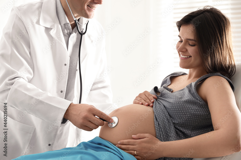 Doctor examining woman before giving child birth in maternity hospital, closeup Doctor examining woman before giving child birth in maternity hospital, closeup
