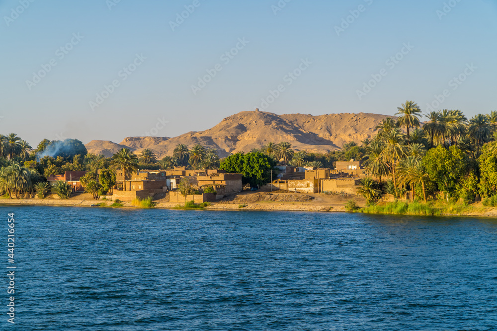 Panoramic view of houses in a traditional village at sunset on the Nile River near Edfu, Egypt