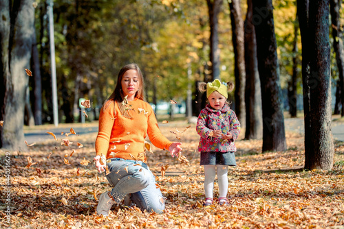 mom and daughter in the autumn sunny park, Warm autumn. Active outdoor games, lifestyle
