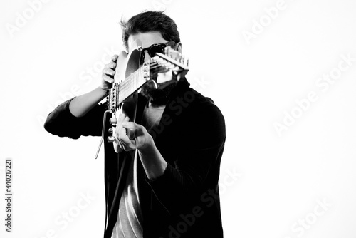 a man with a guitar in his hands music to the performance black and white photo