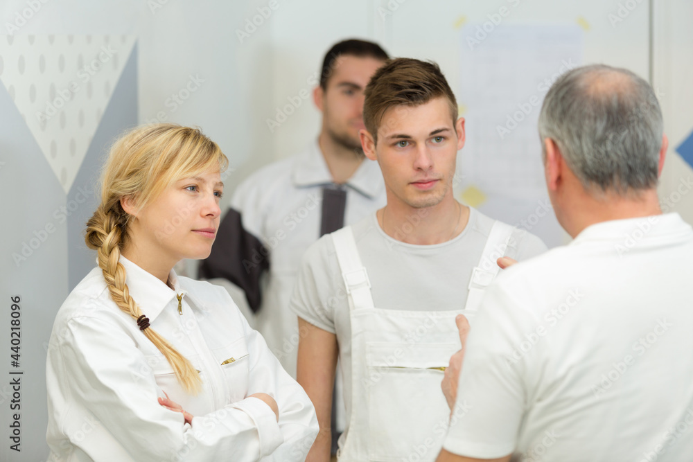 Fototapeta premium portrait of workman talking to apprentices