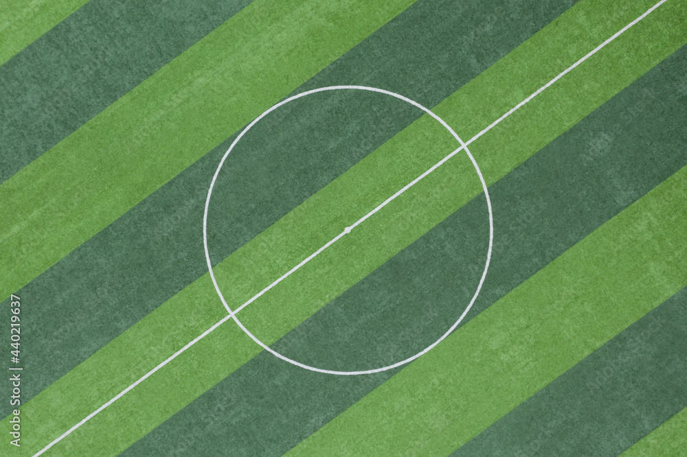 Obraz premium Aerial top view of the green grass texture of the circular area in the center of the soccer field