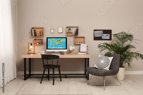 Room interior with comfortable workplace. Modern computer on wooden desk © New Africa