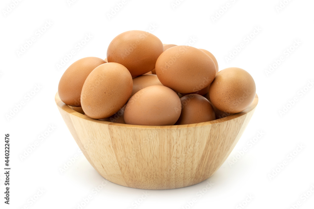 Stacking eggs in wooden bowl isolated on white background. Stacking eggs in wooden bowl isolated on white background.