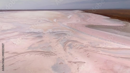 Bird’s eye view endless flat steppe amazing salt lake rose bottom surreal alien divorces pattern. Miracle planet Earth nature landscape. Horizon. Open space. Russia best wild scenery. Healing brine photo