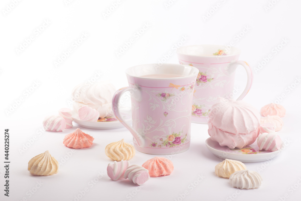 A few sweet meringues and tender marshmallows around cups with fragrant cocoa A few sweet meringues and tender marshmallows around cups with fragrant cocoa